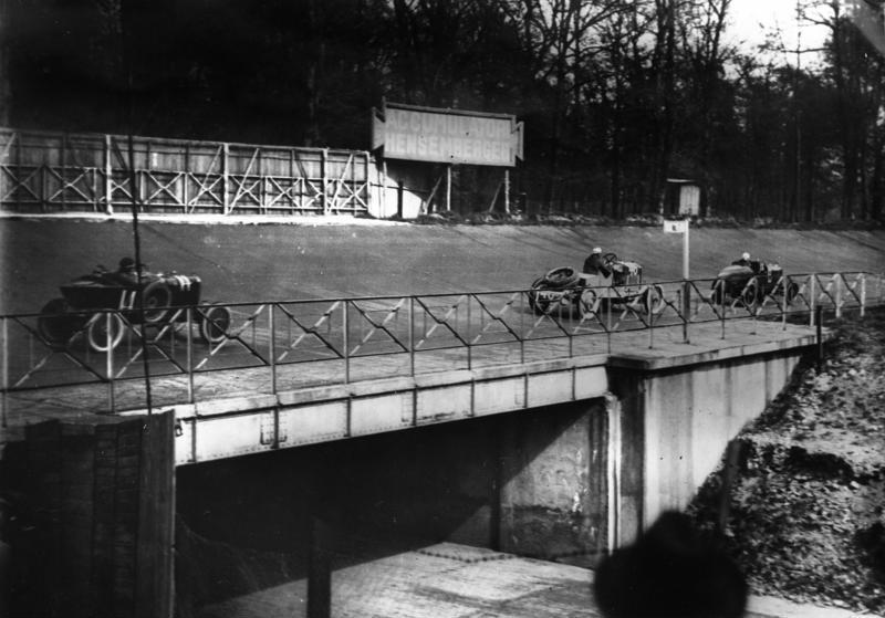 A Race in 1925 with Cars Racing Across the Bridge